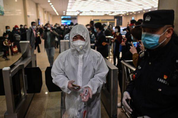 A man arrives at Hankou Railway Station in Wuhan, China to board one of the first trains leaving the city after two and a half months’ lockdown on April 8, 2020. (Hector Retamal/AFP via Getty Images)