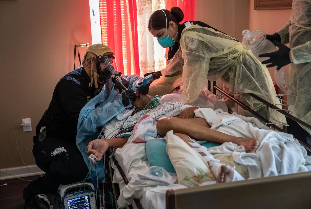 Medics intubate a gravely ill patient with COVID-19 symptoms at his home in Yonkers, New York, on April 6, 2020. (John Moore/Getty Images)
