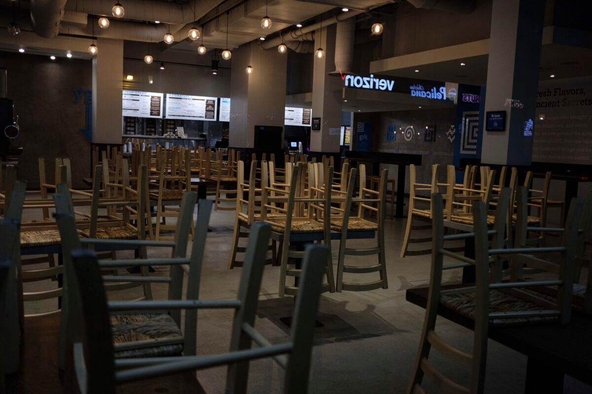 Chairs stacked on empty tables at a closed restaurant in New York City on March 16, 2020. (Yuki Iwamura/AP Photo)