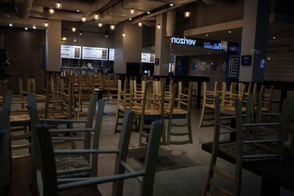 Chairs hang stacked on empty tables at a closed restaurant in New York City, on March 16, 2020. (Yuki Iwamura/AP Photo)