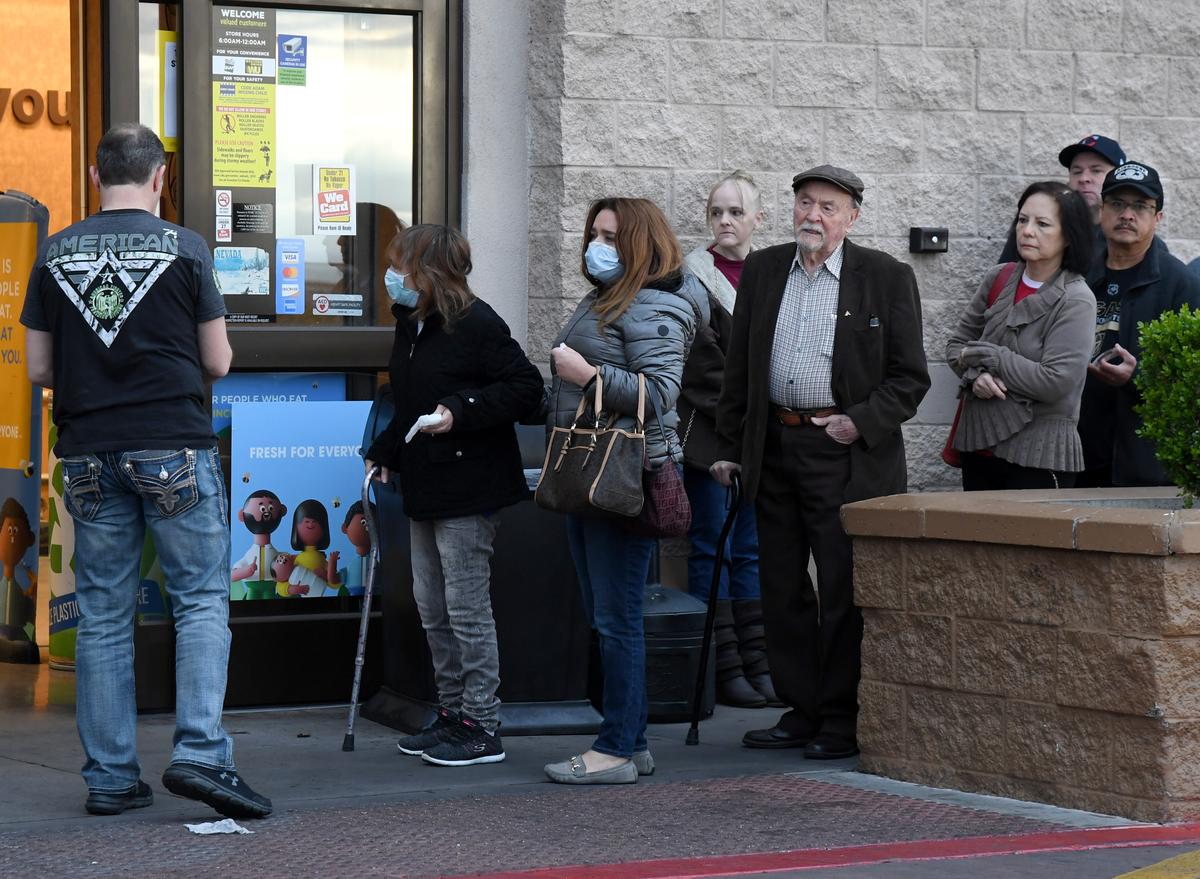 People wait in line to enter a Smith's Food & Drug store in Las Vegas, Nev., on March 20, 2020. (Ethan Miller/Getty Images)