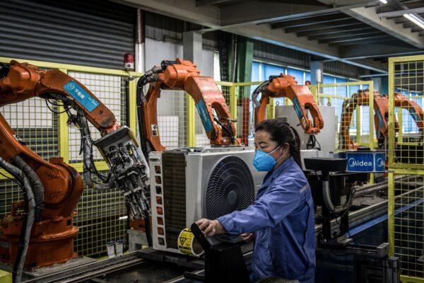 An employee working on an air conditioner production line at a Midea factory in Wuhan in China's central Hubei province, on March 25, 2020. (STR / AFP via Getty Images)