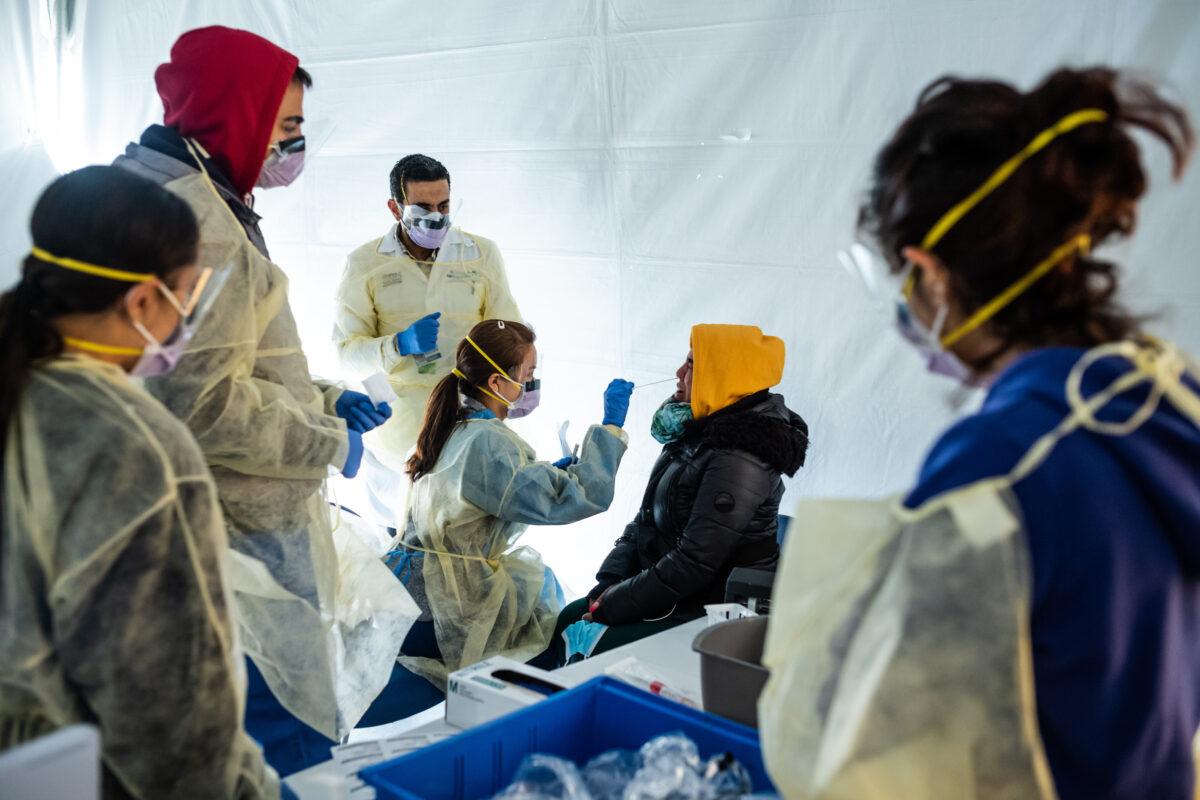 Doctors test hospital staff for COVID-19 in triage tents outside the main emergency department area at St. Barnabas hospital in the Bronx, in New York City on March 24, 2020. (Misha Friedman/Getty Images)