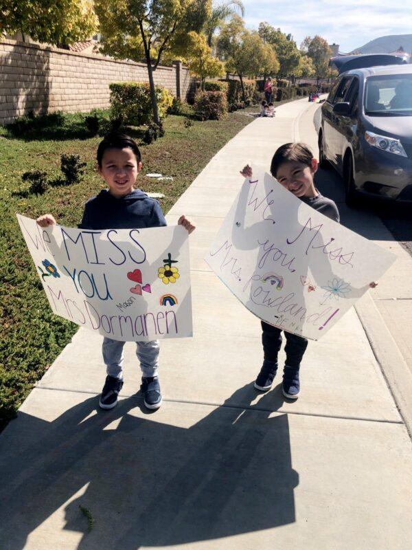 Children hold signs at a car parade organized by teachers in French Valley, Calif. (Courtesy of Darlene Dormanen)