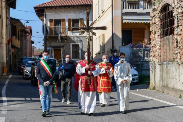 During the country's lockdown aimed at curbing the spread of the COVID-19 infection, caused by the novel coronavirus, Parish priest of the Santa Maria Assunta church in Pontoglio, Don Giovanni Cominardi (C), wearing a face mask, escorted by Pontoglio mayor Alessandro Seghezzi (L), walks during a Via Crucis procession (Way of the Cross) as part of Good Friday celebrations in Pontoglio on April 10, 2020. (Miguel Medina /AFP via Getty Images)