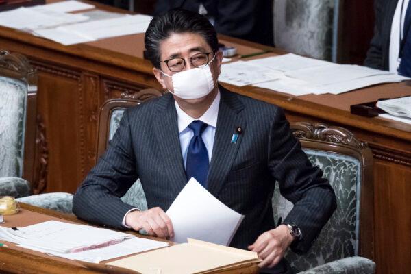Japan's Prime Minister Shinzo Abe wearing a face mask attends an ordinary session at the upper house of parliament in Tokyo, Japan, on April 2, 2020. (Tomohiro Ohsumi/Getty Images)