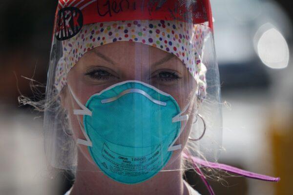 A member of the medical staff listens as Montefiore Medical Center nurses call for N95 masks and other critical PPE to handle the COVID-19 disease pandemic in New York on April 1, 2020. (Bryan R. Smith / AFP via Getty Images)