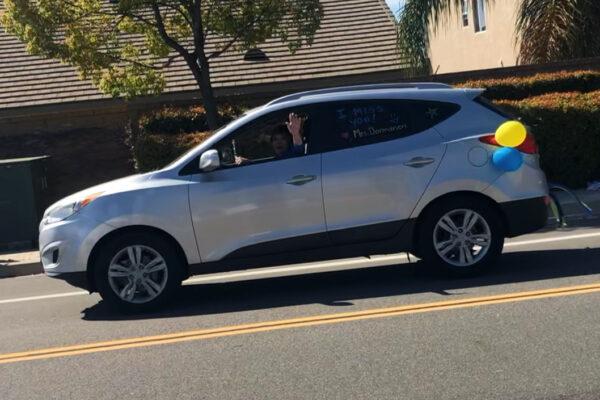 A car parade participant waves to the crowd during a parade of teachers in French Valley, Calif. (Courtesy of Darlene Dormanen)