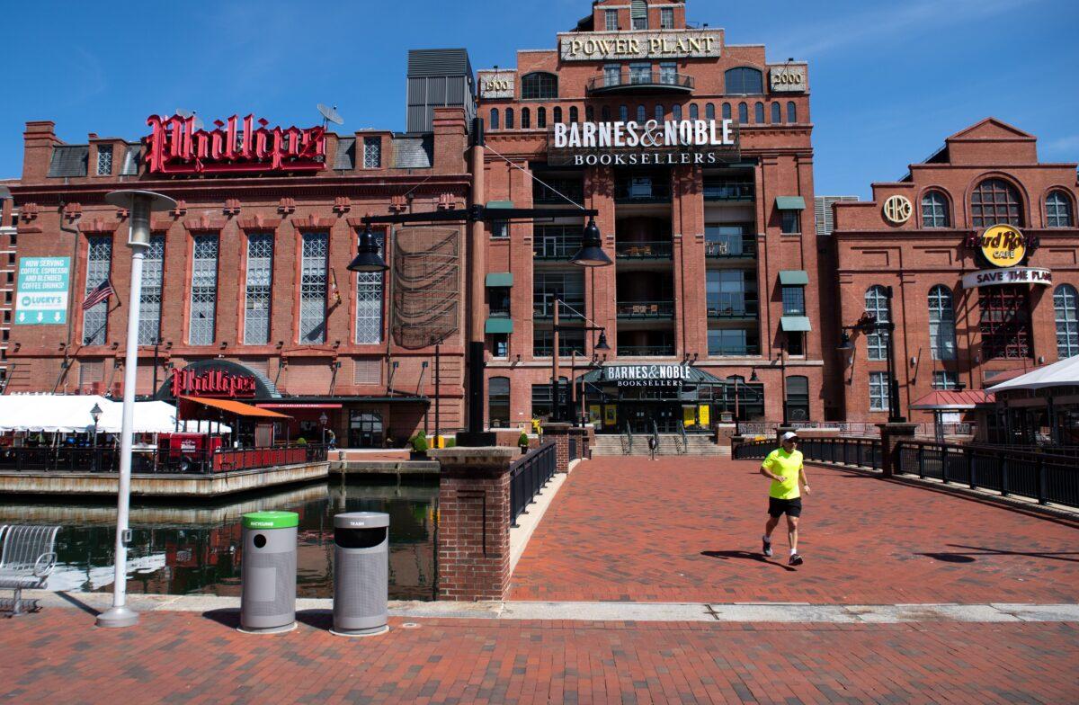 A man runs through a normally busy area of Baltimore's Inner Harbor in Maryland on April 6, 2020. (Saul Loeb/AFP via Getty Images)