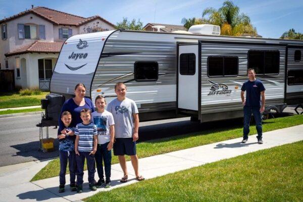 The Hildebrand family stands in front of the family RV, where first responder Anthony self-isolates, in French Valley, Calif. (Courtesy of Karen Hildebrand/Stood Still Photography)