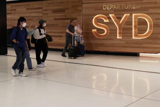 Travellers walk towards the departures gate at the International Airport in Sydney, Australia, on March 25, 2020. (Mark Metcalfe/Getty Images)