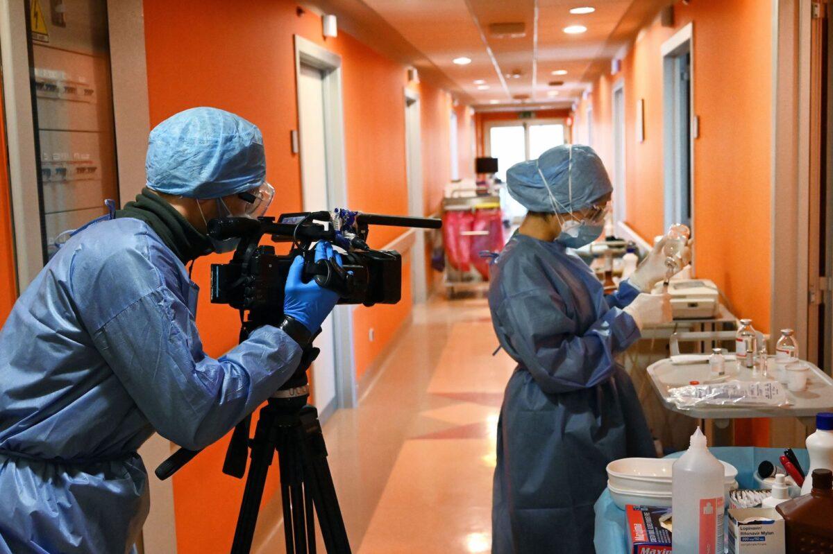 A journalist films a nurse at a COVID-19 intensive care unit at a hospital near Rome, Italy, on April 8, 2020. (Alberto Pizzoli/AFP/Getty Images)