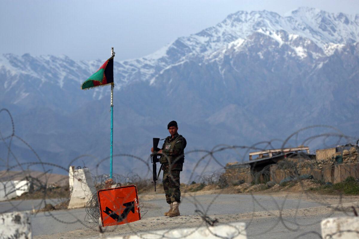 An Afghan National Army soldier stands guard at a checkpoint near the Bagram base north of Kabul, Afghanistan on April 8, 2020. (Rahmat Gul/AP Photo)
