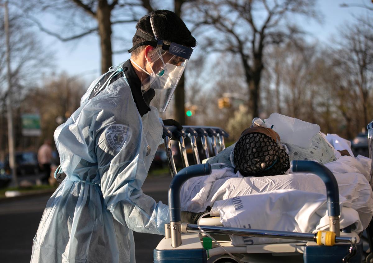 An EMT tends to a COVID-19 patient arriving to the Montefiore Medical Center Wakefield Campus in the Bronx borough of New York City on April 6, 2020. (John Moore/Getty Images)