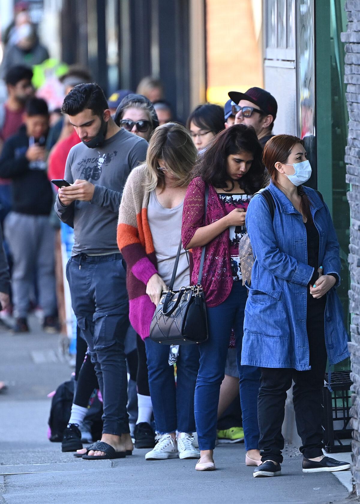 People wait in line to enter Centrelink in Melbourne, Australia, on March 24, 2020. (Quinn Rooney/Getty Images)