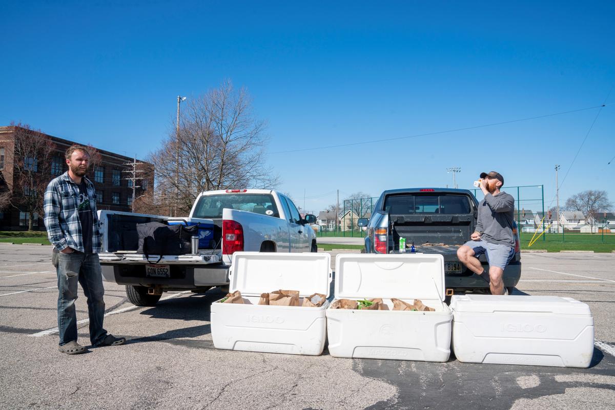Tim Kelly and Jimmy Myers run one of four pickup spots in Madison Park, Lakewood for Front 9 Farm where they have started offering weekly deliveries of vegetables, meats, cheeses and other fresh items following the CCP virus outbreak, in Ohio, U.S., on April 4, 2020. (Dane Rhys/Reuters)