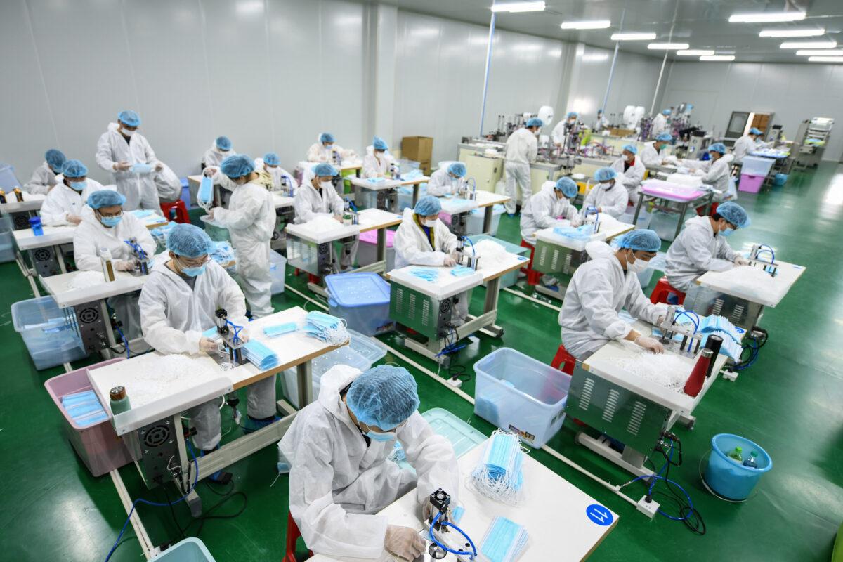 Workers are producing face masks that will be exported at a factory in Nanchang in China's central Jiangxi Province on April 8, 2020. (STR/AFP via Getty Images)