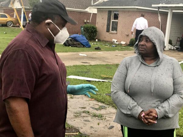 Monroe Mayor Jamie Mayo, talks to a displaced resident after severe storms damaged homes in Monroe, La., on April 12, 2020. (Greg Hilburn/Monroe News Star via AP)