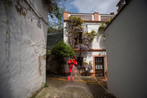 Amid a national lockdown to prevent the spread of the CCP virus, a member of the Spanish Fire Brigade carries out a general disinfection in Ronda, Spain, on April 12, 2020. (Jorge Guerrero /AFP via Getty Images)
