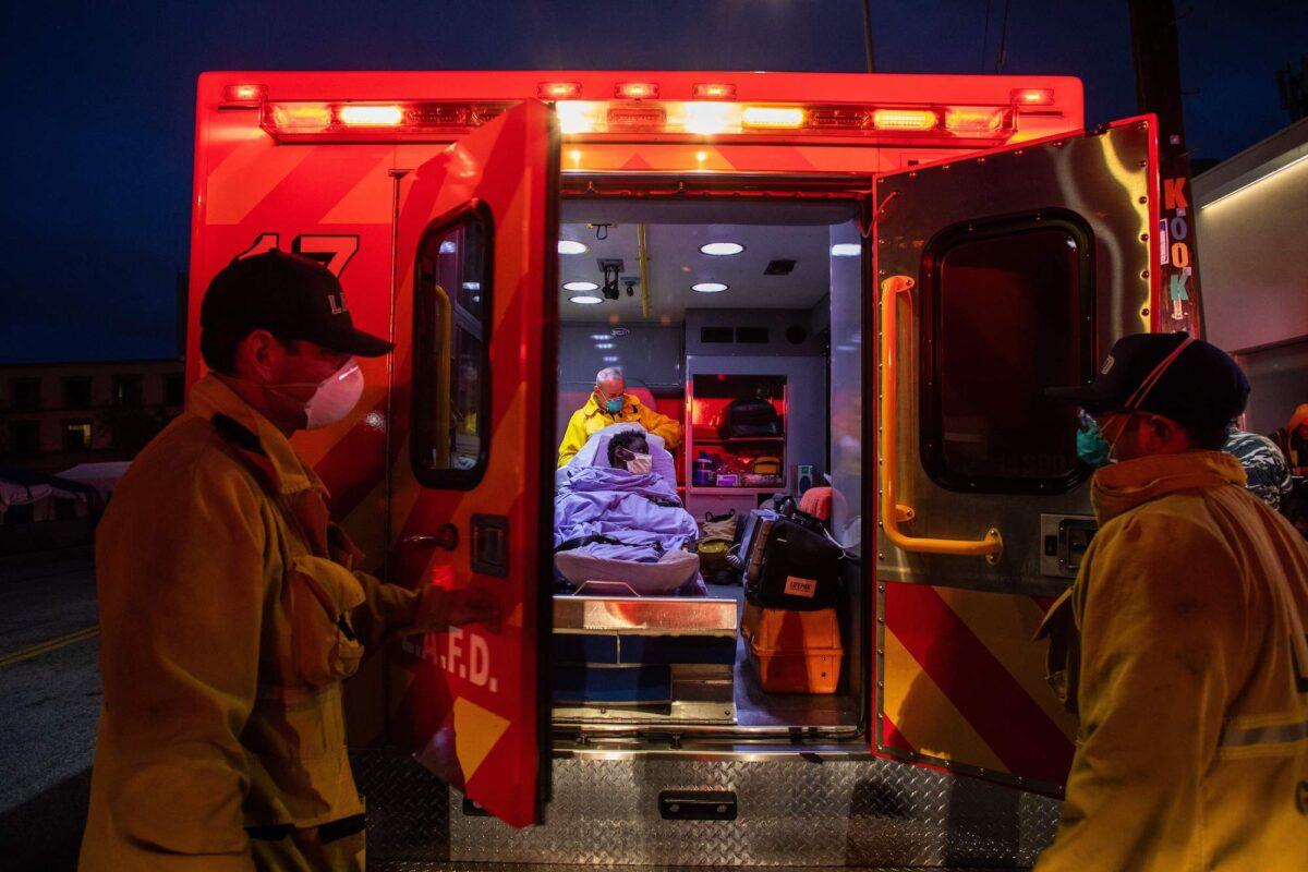 Paramedics attend to a person with possible symptoms of COVID-19 in Los Angeles, California, on April 12, 2020. (Apu Gomes/AFP/Getty Images)