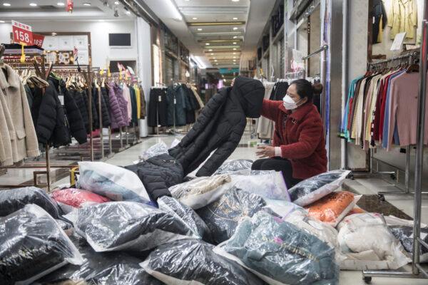 A vendor sorts out clothes in Hankou north international commodity exchange center in Wuhan, Hubei province, China, on March 29, 2020. (Getty Images)