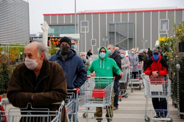 People line up to enter a hardware store during a partial reopening after the Austrian government eased restrictions following the CCP virus outbreak in Eisenstadt, Austria, on April 14, 2020. (Leonhard Foeger/Reuters)