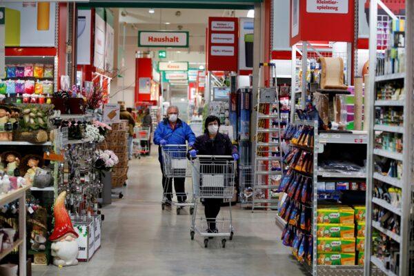 People wearing masks shop in a hardware store during a partial reopening after the Austrian government eased restrictions following the CCP virus outbreak in Eisenstadt, Austria, on April 14, 2020. (Leonhard Foeger/Reuters)