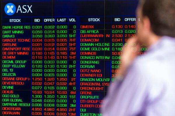 A man looks at the electronic display of stocks at the Australian Stock Exchange in Sydney, Australia, on March 13, 2020. (Jenny Evans/Getty Images)
