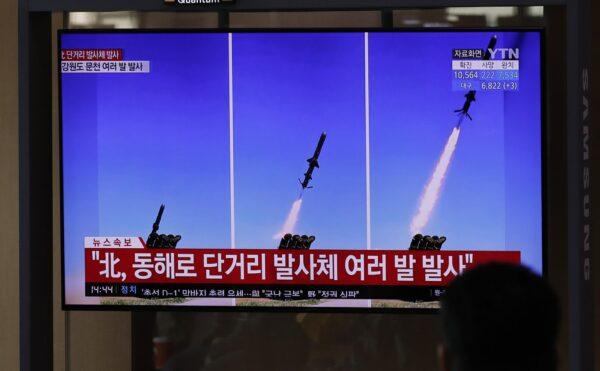 People watch a TV screen airing reports about North Korea's firing missiles with file images of missiles at the Seoul Railway Station in Seoul on April 14, 2020. (Lee Jin-man/AP Photo)
