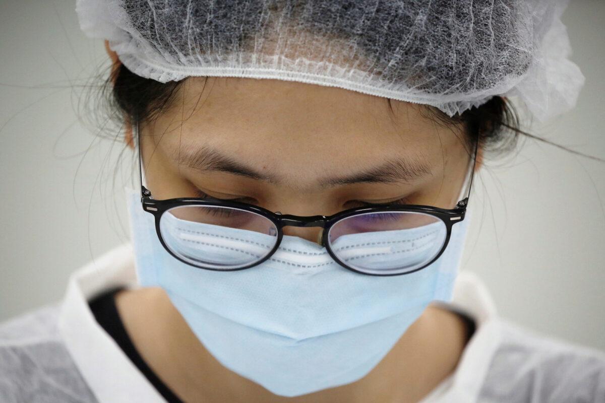 A production line worker wears a protective mask at a factory in Taoyuan city, Taiwan, on April 6, 2020. (Reuters/Ann Wang)