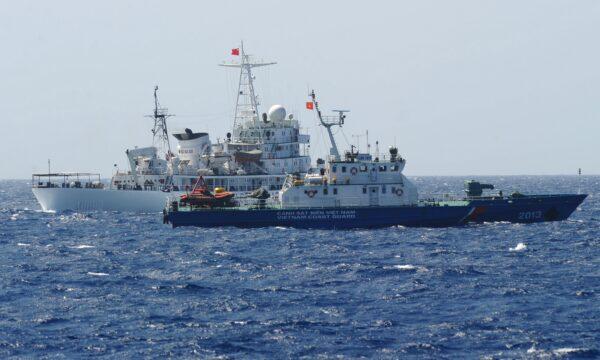 A Chinese coast guard ship (back) sails next to a Vietnamese coast guard vessel (front) near China's oil drilling rig in disputed waters in the South China Sea on May 14, 2014. (Hoang Dinh Nam/AFP via Getty Images)