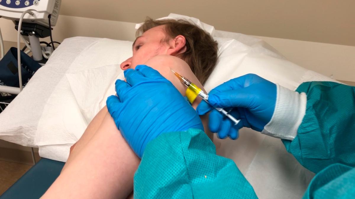 A participant in a COVID-19 vaccine trial receives an injection in Kansas City, Mo., on April 8, 2020. (Center for Pharmaceutical Research via AP)