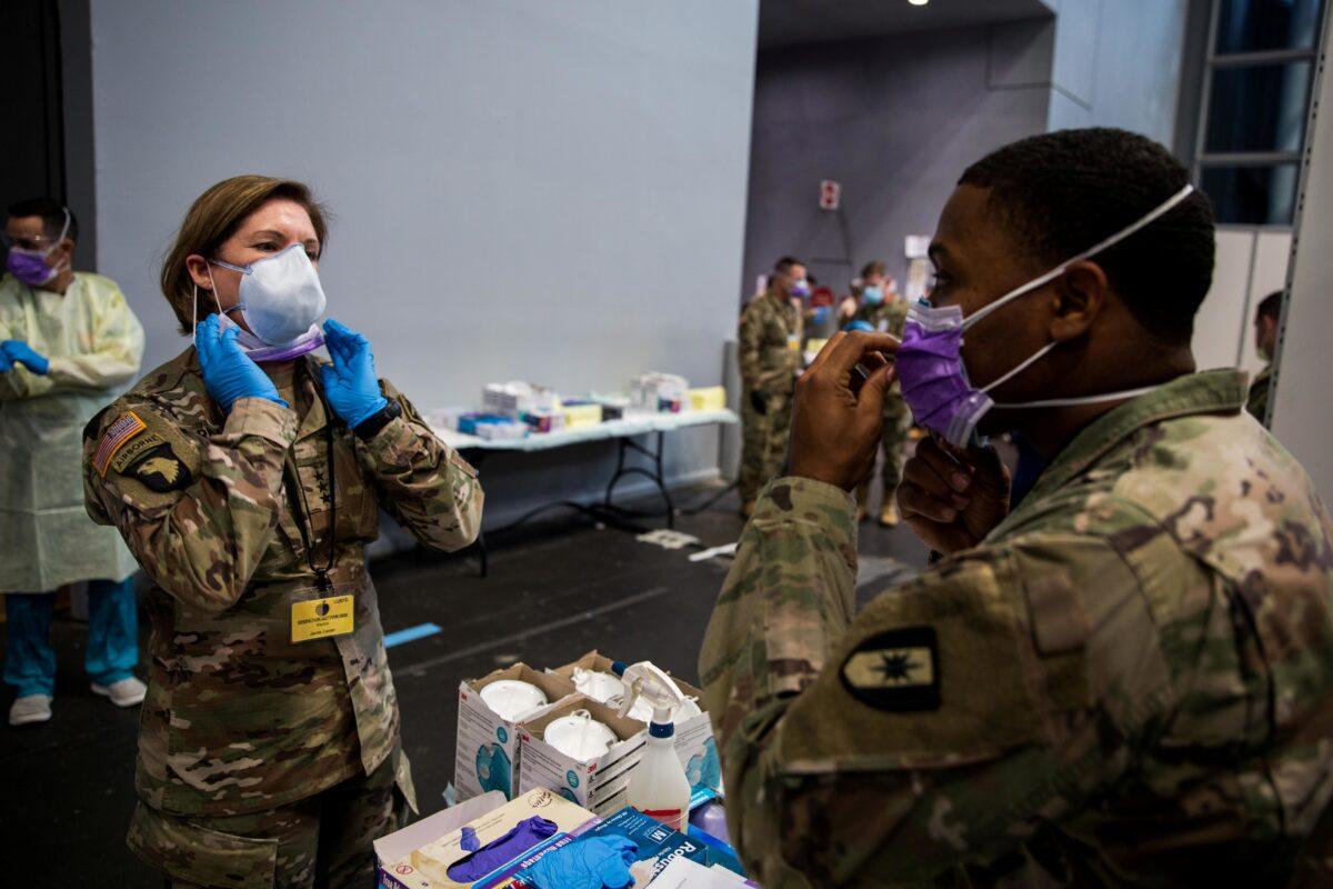 Army Lieutenant General Laura Richardson, commanding general of U.S. Army North, puts on personal protective equipment before entering the patient care area at Javits New York Medical Station, which is supporting local hospitals treating the CCP virus in New York City on April 12, 2020. (U.S. Navy/Chief Mass Communication Specialist Barry Riley/Handout via Reuters)