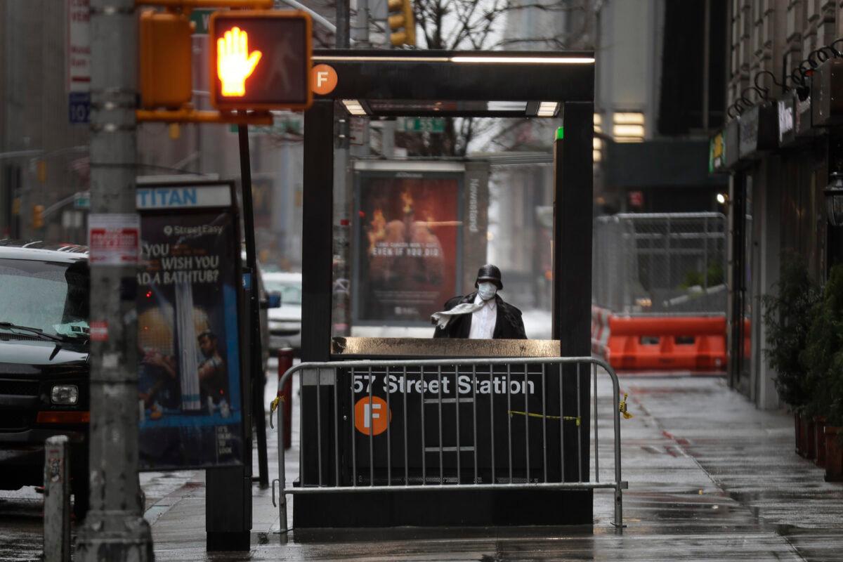 A man enters the subway on a rainy day in New York City on April 13, 2020. (Seth Wenig/AP Photo)