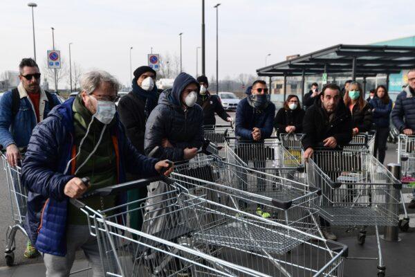 Residents wait to be given access to shop in a supermarket in small groups of forty people in the small Italian town of Casalpusterlengo, on Feb. 23, 2020. (Miguel Medina/AFP via Getty Images)