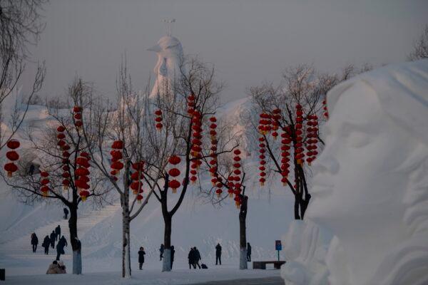 Tourists walk past ice sculptures during the Harbin International Ice and Snow Festival in Harbin, in China's northeast Heilongjiang province on Jan. 5, 2020. (Noel Celis/AFP via Getty Images)