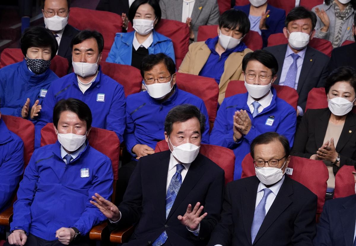 Lee Nak-yon, South Korean former Prime Minister and the ruling Democratic Party candidate for the parliament, wears a face mask as he watches a news report on results of exit polls in the parliamentary elections, amid the COVID-19 outbreak, in Seoul, South Korea, on April 15, 2020. (Kim Hong-Ji/Reuters)