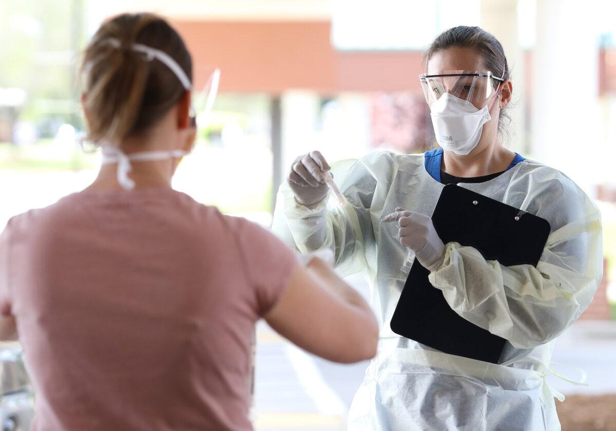 A nurse administers COVID-19 testing at a drive-up facility at MedStar St. Mary's Hospital in Leonardtown, Md., on April 14, 2020. (Win McNamee/Getty Images)