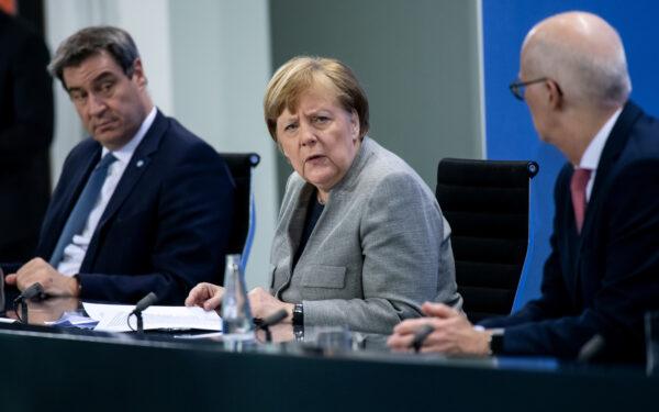 German Chancellor Angela Merkel, Bavarian Prime Minister Markus Soeder, and Hamburg Mayor Peter Tschentscher hold a news conference after discussing with German state premiers on whether to prolong or phase-out the lockdown at the Chancellery in Berlin, Germany, April 15, 2020. (Bernd von Jutrczenka/Pool via Reuters)