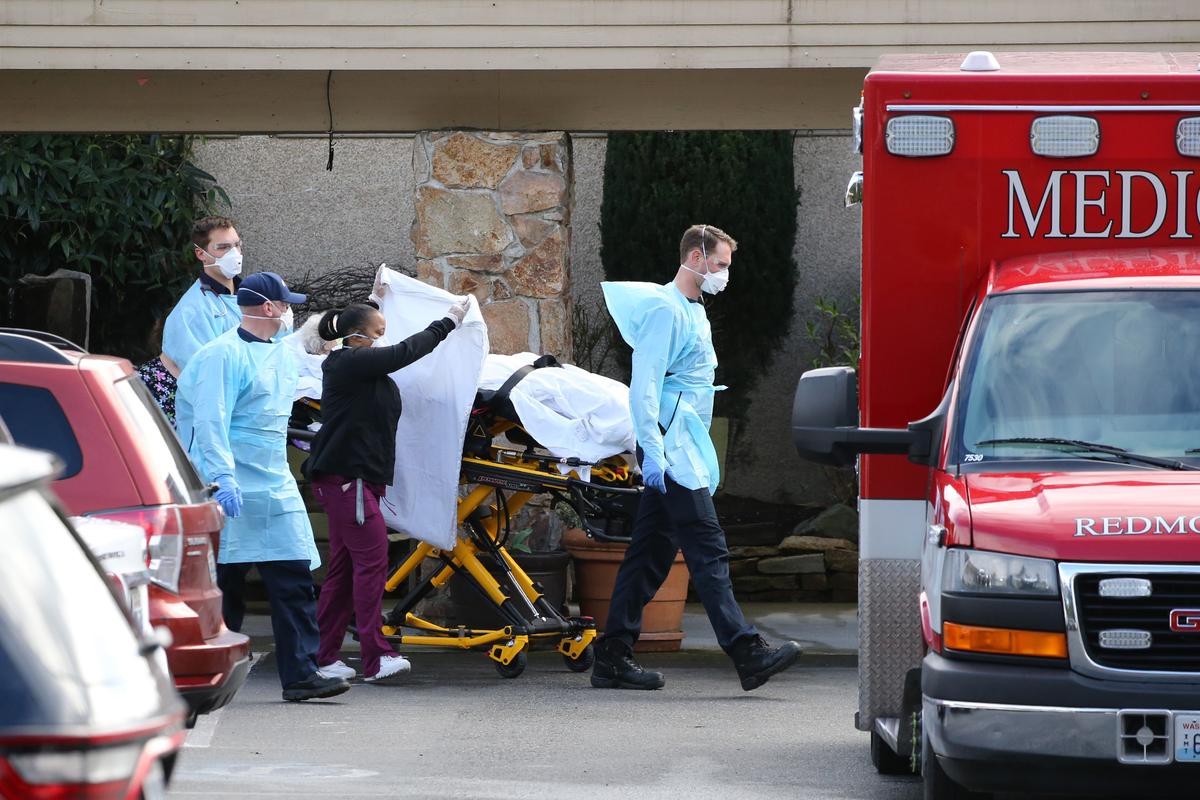 A patient is transferred into an ambulance at the Life Care Center in Kirkland, Washington, on March 7, 2020. (Karen Ducey/Getty Images)