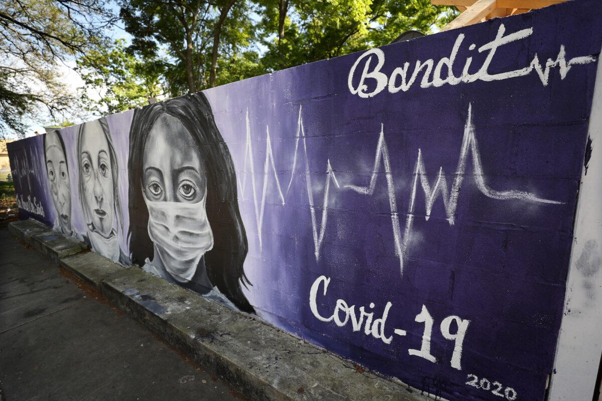 A COVID-19 themed artwork is seen on a wall in the lower ninth ward in New Orleans, Louisiana, on April 03, 2020. (Chris Graythen/Getty Images)