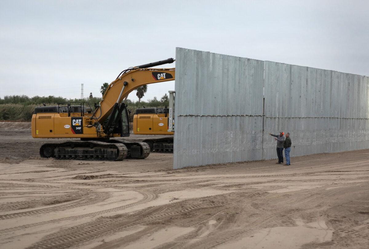 A loader grades land near a section of privately-built border wall under construction near Mission, Texas, on Dec. 11, 2019. (John Moore/Getty Images)