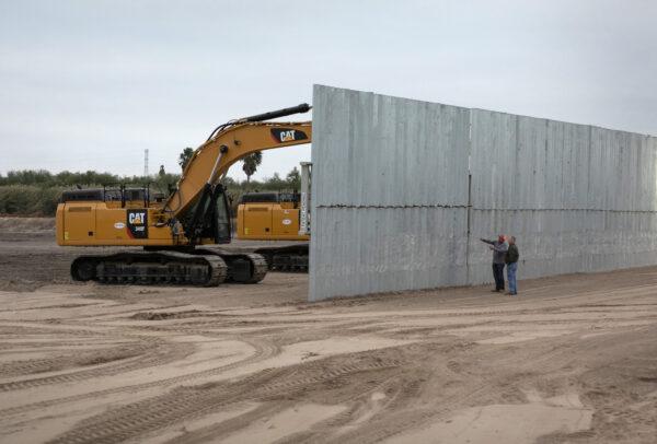A loader grades land near a section of privately-built border wall under construction near Mission, Texas, on Dec. 11, 2019. (John Moore/Getty Images)