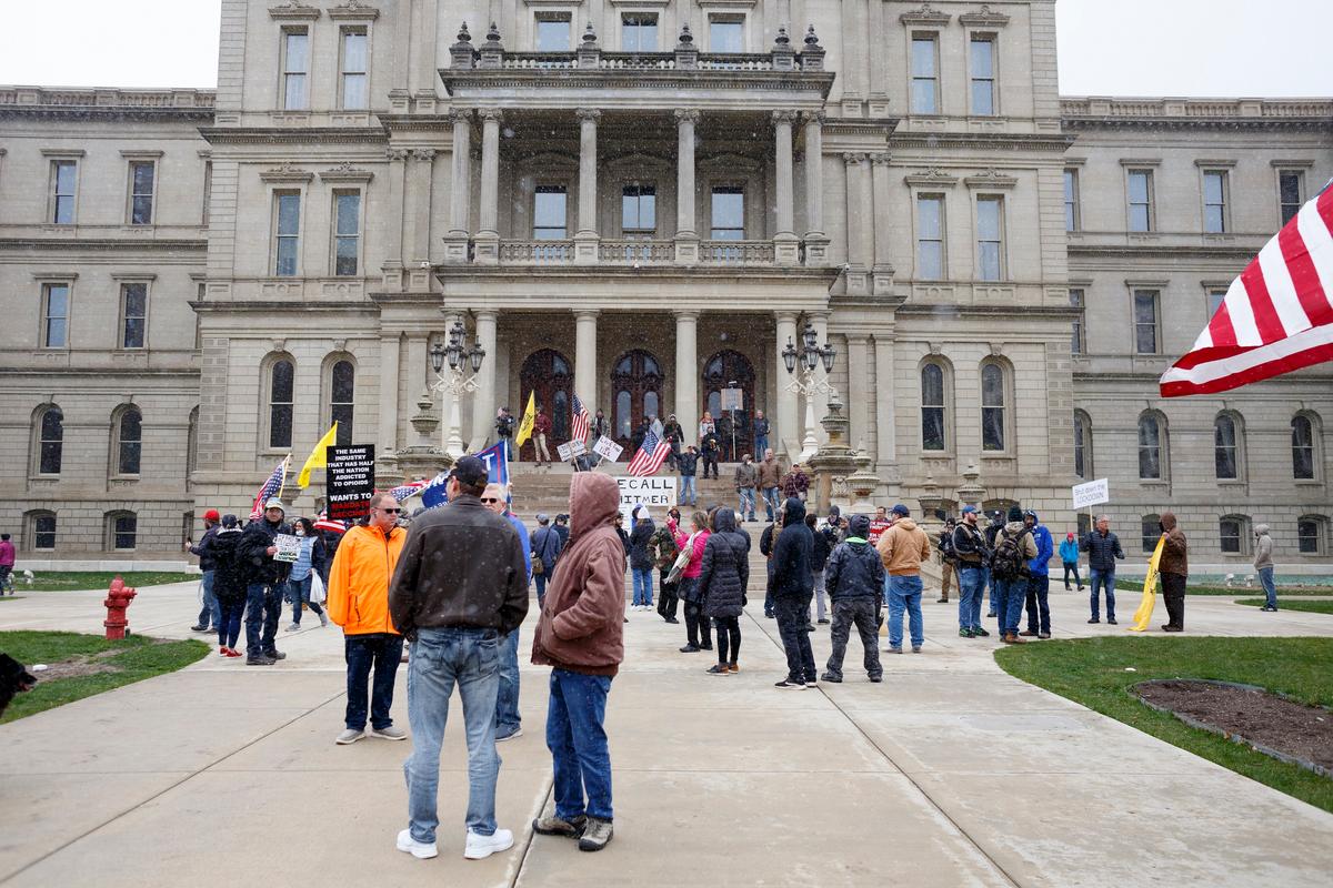 People gather on the Michigan Capitol's steps to protest Gov. Gretchen Whitmer's stay-at-home executive order in Lansing, Michigan, on April 15, 2020. (Elaine Cromie/Getty Images)