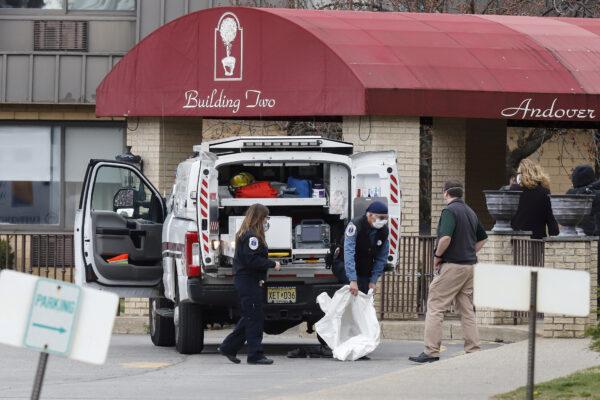 Paramedics and healthcare officials are seen outside Andover Subacute and Rehab Center, during the CCP virus outbreak, in Andover, N.J., on April 16, 2020. (Stefan Jeremiah/Reuters)