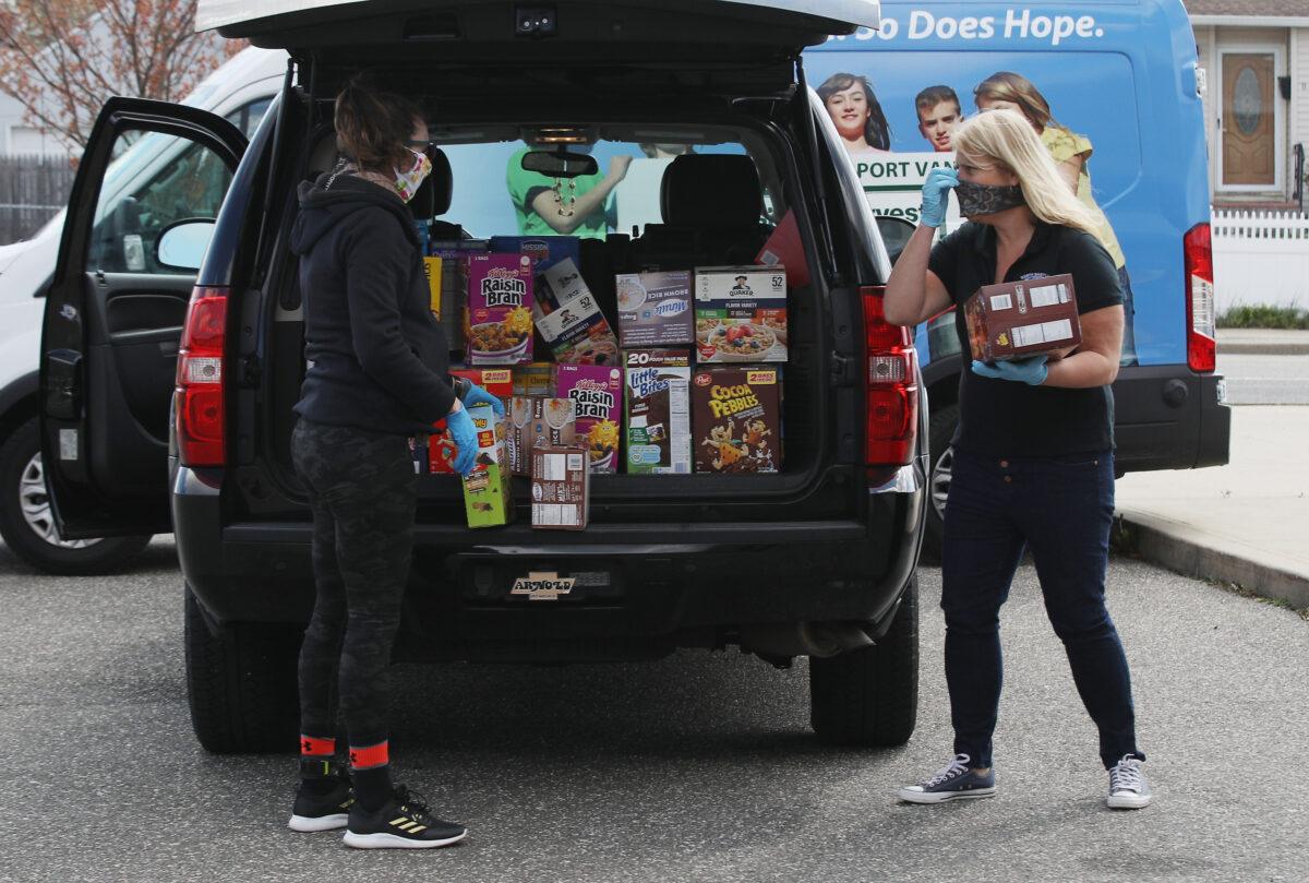 Goods are donated for distribution to those in need at North Babylon High School in New York on April 16, 2020. (Bruce Bennett/Getty Images)
