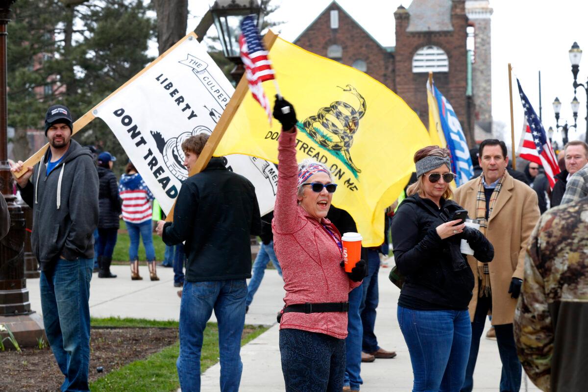 Protesters attend a rally outside the State Capitol in Lansing, Michigan on April 15, 2020. (Paul Sancya/AP Photo)