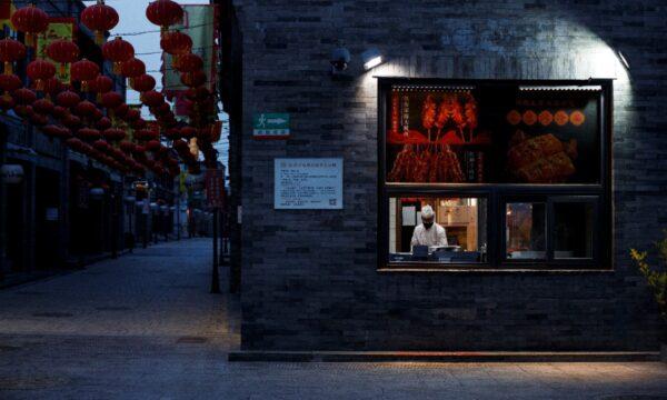 A chef prepares food in the Qianmen district, one of the top tourist destinations in Beijing, as the spread of the CCP virus continues in China, on April 8, 2020. (Thomas Peter/Reuters)