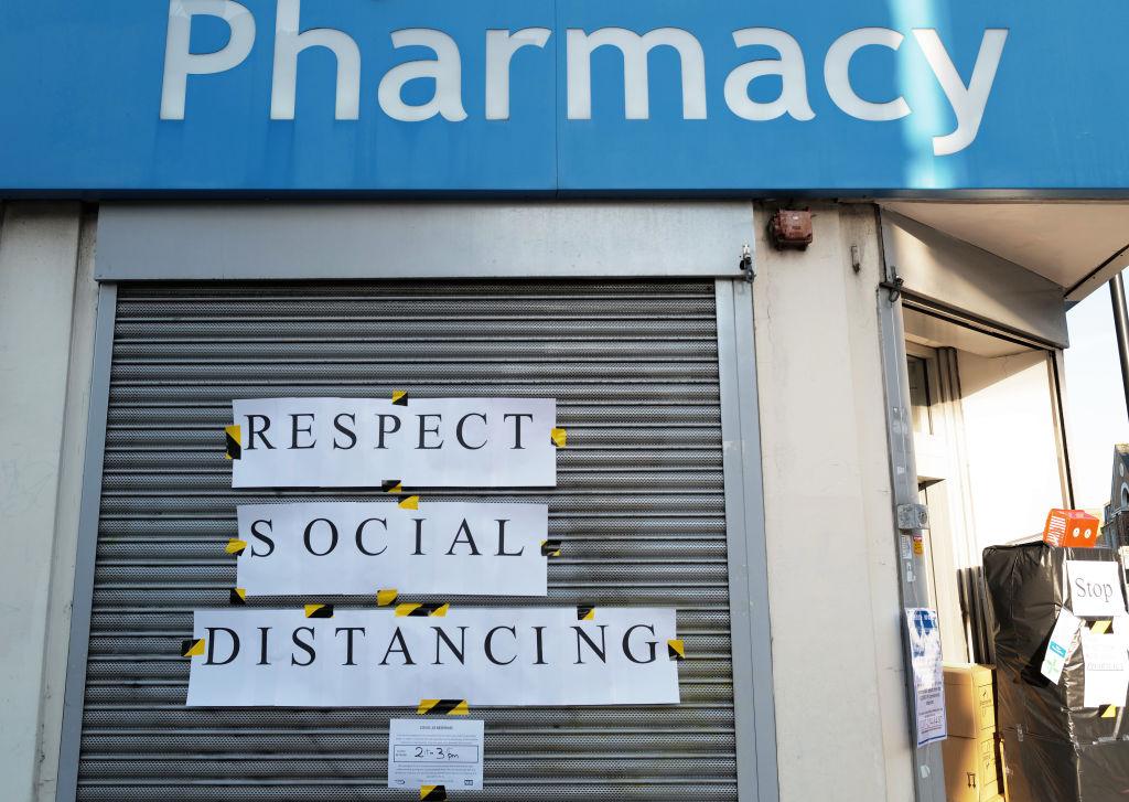 A pharmacy shows signs reminding us of social distancing on March 23, 2020 in London, England. (Julian Finney/Getty Images)