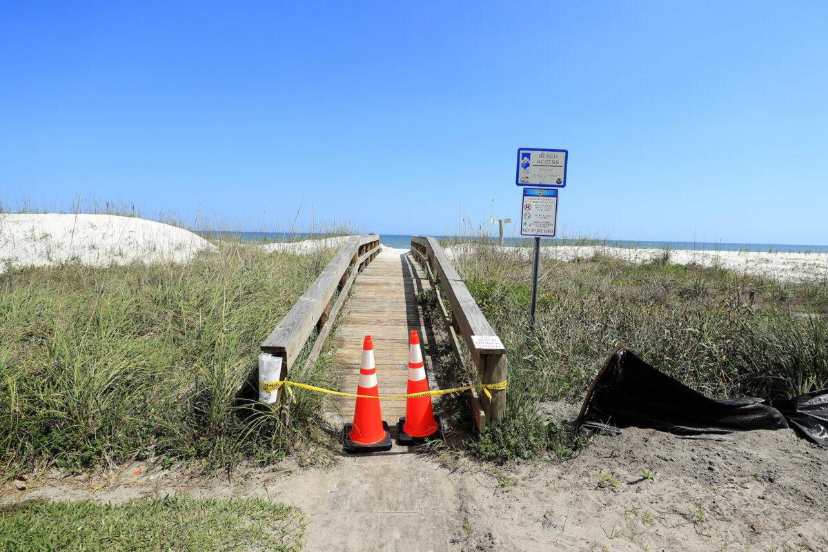 Police tape and pylons block the public access to Jacksonville Beach, in Jacksonville Beach, Florida, on March 21, 2020. (Sam Greenwood/Getty Images)
